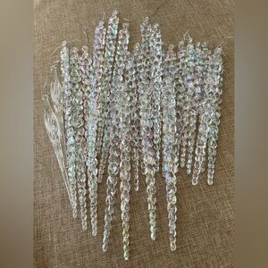 (24) plastic Christmas icicles. (22) braided iridescent, and (2) clear swirl.